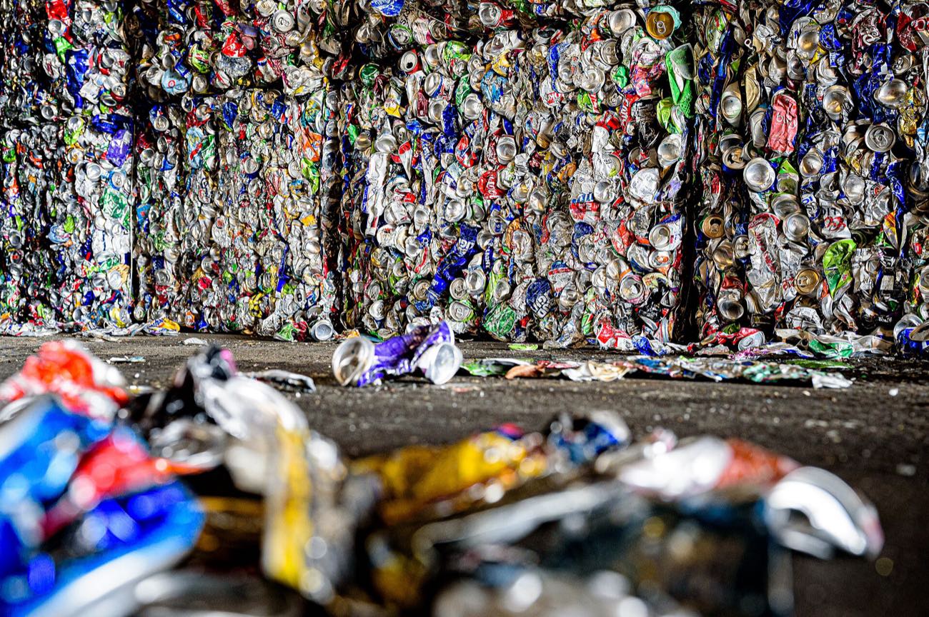 Baled aluminium cans stacked at a recovery facility